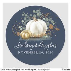 a round sticker with gold and white pumpkins on it, in front of a brown background