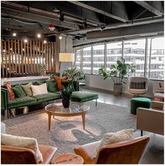 a living room filled with furniture and lots of windows