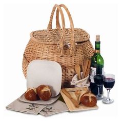 a wicker basket filled with bread and wine