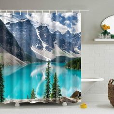 a bathroom with a shower curtain that has a lake in the middle and mountains in the background