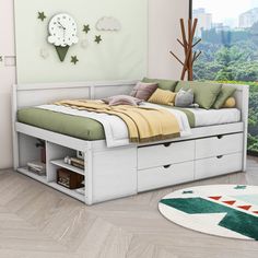 a white bed with drawers underneath it in a room next to a window and rug