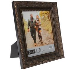 an old wooden frame with a couple walking in the woods