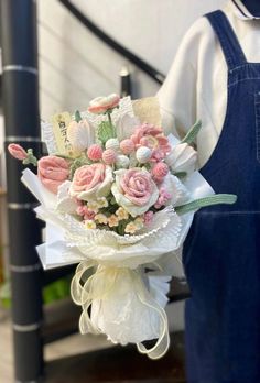 a bouquet of pink and white flowers in front of a stair case at the bottom of stairs