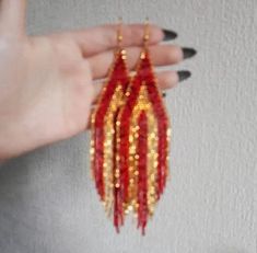 "bright earrings with several types of red and gold Czech beads. Colors: red gold Length: 6 inches (15 cm) Width: 1.5 inches (3.7 cm) Materials: Czech \"Preciosa\" beads Durable synthetic thread" Red Tassel Earrings With Colorful Beads For Festivals, Red Beaded Tassel Earrings For Festival, Red Beaded Dangle Earrings With Tassels, Red Bohemian Beaded Earrings With Gold Beads, Bohemian Red Beaded Earrings With Gold Beads, Red Beaded Tassel Earrings For Party, Handmade Red Tassel Earrings For Festive Occasions, Red Tassel Earrings For Festive Occasions, Gold Long Earrings