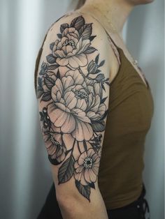 a woman with a flower tattoo on her arm