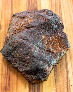 a piece of meat sitting on top of a wooden cutting board