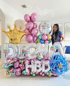 a woman standing in front of balloons that spell out the word big bdg