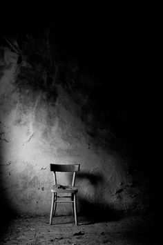 a chair sitting in the middle of a dark room