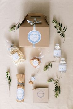 an open box with soap, lotion and other items laid out on a bed