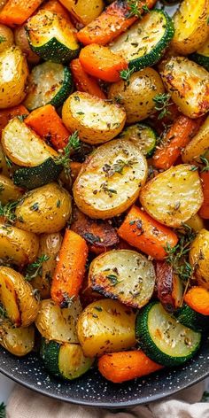 a pan filled with roasted vegetables and herbs