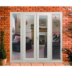 an image of a living room with french doors on the outside and brick wall behind it