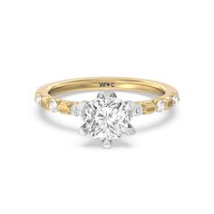 a round cut diamond engagement ring with three stones on the band and an 18k rose gold