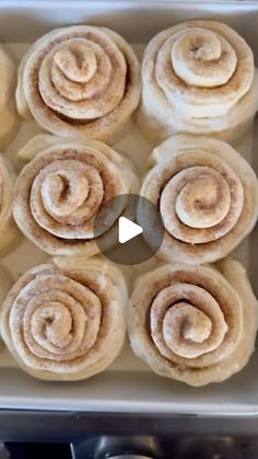 a pan filled with cinnamon rolls sitting on top of a counter