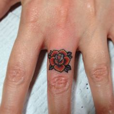 a woman's hand with a rose tattoo on it