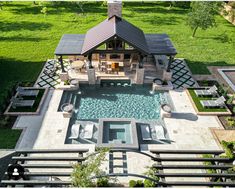 an aerial view of a house with a pool and hot tub in the middle of it