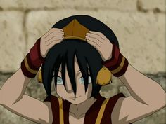 an anime character holding his head with both hands