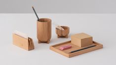 a wooden desk set with pen and pencil holder