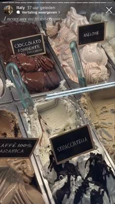 an assortment of ice creams and desserts on display in trays with labels