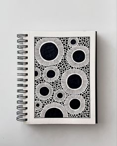 a notebook with black and white designs on it