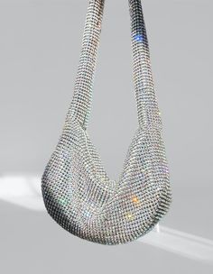 Get ready to dazzle with the Rhinestone Mini Shoulder Bag! This charming accessory features silver-tone accents and sparkling rhinestone embellishments, giving it a vintage feel. Available in silver, red, and green, it's the perfect choice for a fun night out. Equipped with a top zip and a sleek silver shoulder strap, this bag has plenty of space for all your essentials. It's got the perfect fit for your shoulder and ample sparkle from glass crystals. With dimensions of 12 inches in width, 7 inc Rhinestone Embellishments, Mini Shoulder Bag, Green Bag, Design Crafts, Fashion Forward, Silver Tone, Night Out, Shoulder Strap, Lounge Wear