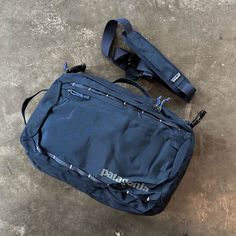 Discontinued By Patagonia, This Is A Perfect Everyday Or Travel Bag. New Without Tags. Patagonia's Tres 25l Backpack Works Overtime By Doubling As A Shoulder Bag And A Briefcase For Everyday Life. The Padded Shoulder Straps Tuck Into The Mesh Back Panel, And The Removable Shoulder Strap Attaches To Work As A Shoulder Bag, Or You Can Keep The Shoulder Strap Off And Grab The Backpack Like A Briefcase. Patagonia Made This Pack Out Of Durable, Water-Repellent Fabric To Shed Rainfall Or Accidental Dr Patagonia Functional Everyday Bag, Functional Patagonia Travel Bags, Functional Patagonia Outdoor Bags, Patagonia Nylon Travel Bag, Patagonia Nylon Bag For Outdoor, Practical Blue Backpack For Hiking, Patagonia Bags, Shoulder Bag Outfit, Carry On Backpack