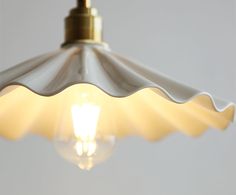 a light that is hanging from the ceiling with a bulb on it's side