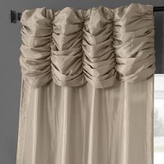 a curtain with ruffles hanging from it's side