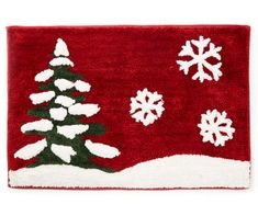 a red rug with white snowflakes and a christmas tree on it's side