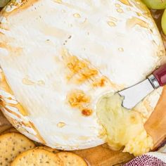 a cheese board with grapes and crackers on it