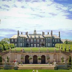 a large building with many windows and lots of greenery