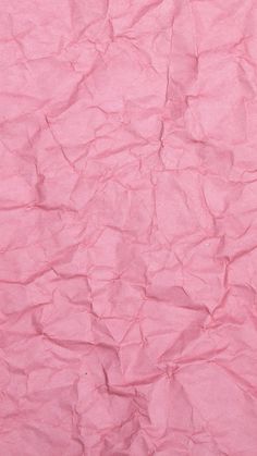 a pink background with wrinkled paper on it