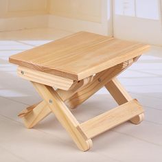 a small wooden table sitting on top of a hard wood floor