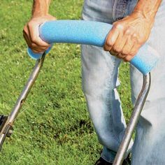 a man is using a lawn mower on the grass