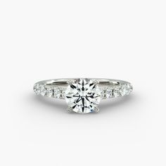 a round brilliant cut diamond engagement ring with side stones