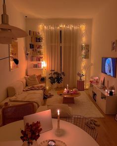 a living room filled with furniture and a flat screen tv on top of a wooden table