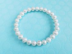 Genuine cultured freshwater pearl bracelet,bridesmaid gift Pearl size:7-8mm pearl shape:near round Color: creamy white Pearl luster: Good Pearl nacre: very thick Elastic pearl bracelet This is a perfect gift for birthday , wedding... in the very attractive price. Please let me know what you want to say on the note card Dear pearl lovers, all pearls in Pearl Select are 100% Real Genuine Cultured freshwater pearls We do not sell faux pearls,imitation pearl,fake pearls,swarovski pearls. Thank you s Pearl Bracelet Bridesmaid Gift, Elegant Pearl Bracelet For First Communion, Pearl White Beaded Pearl Bracelets For Bridesmaids, Pearl White Bridesmaid Pearl Bracelet, Hypoallergenic Pearl Bracelets, Pearl Beaded Bracelets For Bridesmaid Gift With Round Beads, Pearl Beaded Bracelets For Bridesmaid Gift, Elegant Pearl Bracelet With Pearl Charm For First Communion, Pearl Beaded Bracelets With Round Beads For Bridesmaid Gift