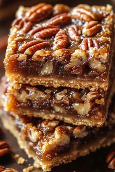 three pieces of pecan bar stacked on top of each other