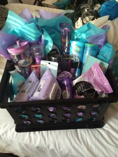 a black basket filled with lots of different types of beauty products and personal care items