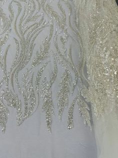 Elegant White Sequin Fabric For Wedding, White Embellished Embroidered Fabric For Festive Occasions, White Wedding Dress With Pearl Embroidery For Reception, White Embellished Embroidered Fabric For Ceremony, Elegant White Sequin Fabric For Festive Occasions, White Embroidered Wedding Dress For Party, White Embellished Wedding Dress For Ceremony, Embellished White Wedding Dress For Ceremony, White Embroidered Fabric For Reception