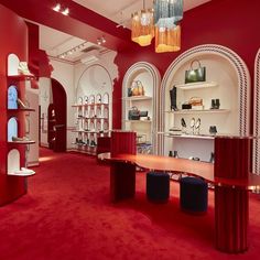 the inside of a shoe store with red carpet