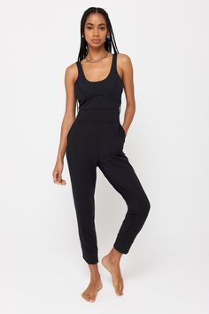 A fitted, ankle-length jumpsuit. Designed with side slant pockets and an interior shelf bra. This mid-weight jersey material feels like you're wearing nothing. We’ve brushed the inside so it's extra soft against the skin. It’s moisture wicking breathable making this the perfect active material that will allow movement and comfort, on and off the mat. | Maggie Active Bodysuit in Black Black Athleisure Jumpsuit With Built-in Bra, Casual Compressive Jumpsuits And Rompers, Athleisure Jumpsuits And Rompers With Pockets For Loungewear, Sporty Jumpsuits And Rompers With Pockets, Sporty Jumpsuits And Rompers With Built-in Bra, Black Elastane Jumpsuits And Rompers For Loungewear, Solid Second-skin Jumpsuits And Rompers For Workout, Black Athleisure Jumpsuits And Rompers With Built-in Bra, Fitted Athleisure Jumpsuits And Rompers In Solid Color