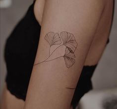 a woman with a flower tattoo on her arm