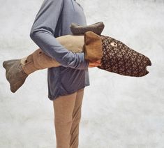 a man holding two stuffed animals in his hands