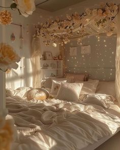 a white bed topped with lots of pillows next to a window covered in curtains and lights