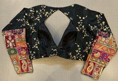 Beautiful black embroidered saree blouse with multi patch sleeves. Buy designer blouse in USA from Pure Elegance. Disclaimer: The actual product may vary slightly from the image. These are custom orders, hence expect slight variation in color, placement of the motif or buta. ESTIMATED DELIVERYBecause this is a custom order, it would take about 4 weeks from the date of purchase. RETURN POLICY: This product is a custom order and cannot be returned or exchanged. Embroidered Saree Blouse, Blouse Corset, Black Embroidered Blouse, Banarasi Sari, Designer Sari, Saree Blouses Online, Blouse Designer, Corset Blouse, Saree Style