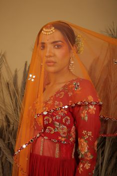 Featuring a red anarkali in chinon chiffon and georgette base with aari, mirror, and zardosi embroidery. It is paired with a contrasting net dupatta. Red Anarkali Set With Sheer Dupatta For Eid, Eid Red Anarkali Set With Sheer Dupatta, Red Sharara With Zari Work, Red Anarkali Sharara With Zari Work, Red Chinon Sharara With Cutdana Detail, Red Anarkali Salwar Kameez With Gota Work, Red Chinon Sharara With Cutdana, Diwali Anarkali Set With Mirror Work In Georgette, Anarkali Sharara With Dupatta For Festive Occasions