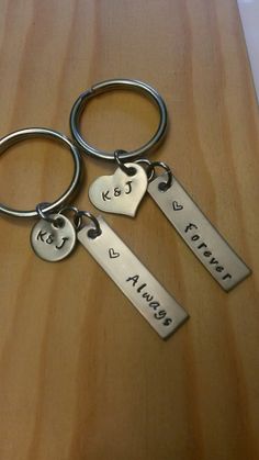 three personalized keychains with two hearts and the words keep forever on them