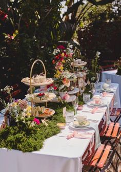 a long table with plates and cups on it