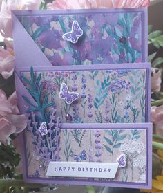 a close up of a card with flowers and butterflies