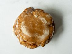 a cookie with icing on it sitting on a table